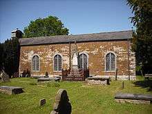 A simpled small church with a bellcote on the left gable