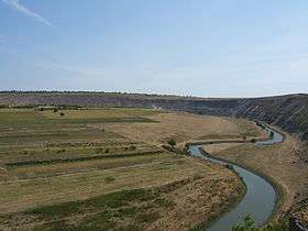 River winding past low farmland