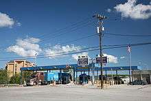 Smaller toll plaza, with semi-trailer truck at a booth