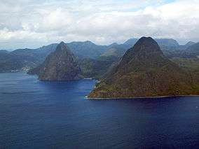 A pair of steep conical rocks rising from the sea.