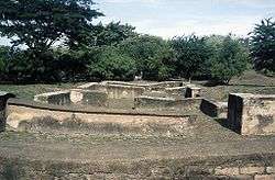 Ruins consisting of foundations of small buildings.