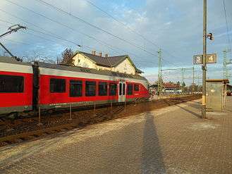 From the same angle as the previous photograph, six years later. The MÁV branding has been removed from the station building. New trains built by Siemens now run along line 120a, the photograph shows one awaiting to depart its return run to Budapest.