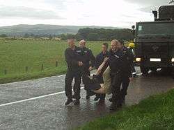 SEG remove protestor from road