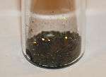 Black lumps in a glass beaker