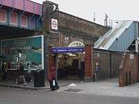 high-level station up stairs on brick viaduct near the market