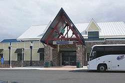 Entrance to building with pointed arch, with a bus in front