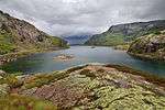 A lake surrounded by forest and hills