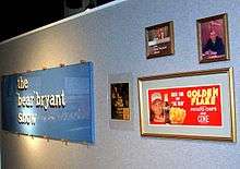 Display of American football memorabilia hanging on a wall.