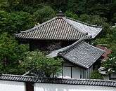 Wooden building with pyramid shaped roof.