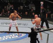 Junior dos Santos, in white shorts, and Shane Carwin, in black shorts, during an MMA fight at the main event of UFC 131 in Vancouver, British Columbia, on June 11, 2011.