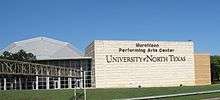 Large building with the words "Murchison Performing Arts Center University of North Texas" displayed in large letters.