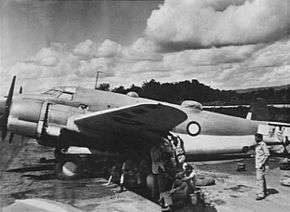 Side view of twin-engined cargo plane on landing ground