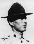 Head and shoulders of a U.S. Marine wearing a 1920s flat-brimmed campaign hat in bright sun.