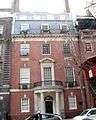  A brick townhouse with slate roof and semicircular entrance portico