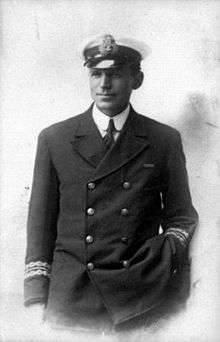 Man in dark naval uniform and wearing an officer's cap