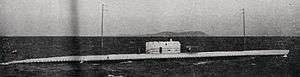 black and white photograph of a submarine underway on the surface