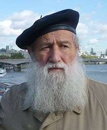 photographic portrait of an older white man with a long grey beard